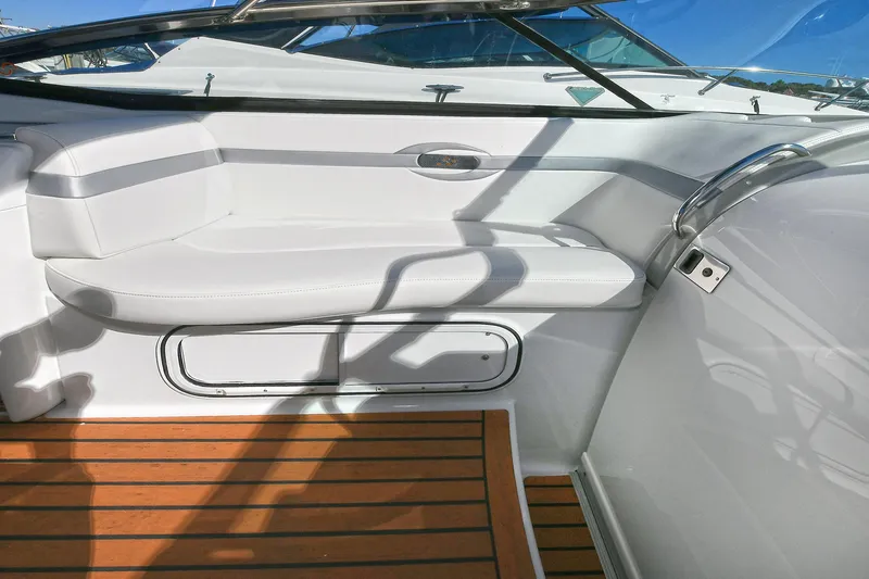 Slide: The Image of 2010 Formula 350 SS boat interior with white seating and wooden flooring. - 24
