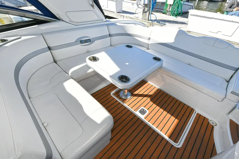 Slide: The Image of 2010 Formula 350 SS boat interior with white seating and wooden deck. - 28