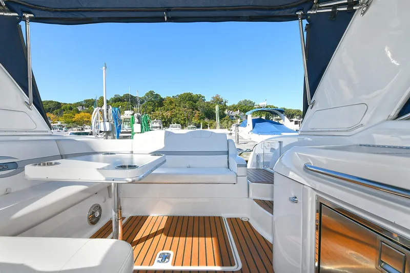 Slide: The Image of 2010 Formula 350 SS boat interior with seating and table, docked at marina. - 29