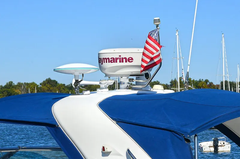 Slide: The Image of 2010 Formula 330 SS Super Sport boat with radar and American flag on blue water. - 3