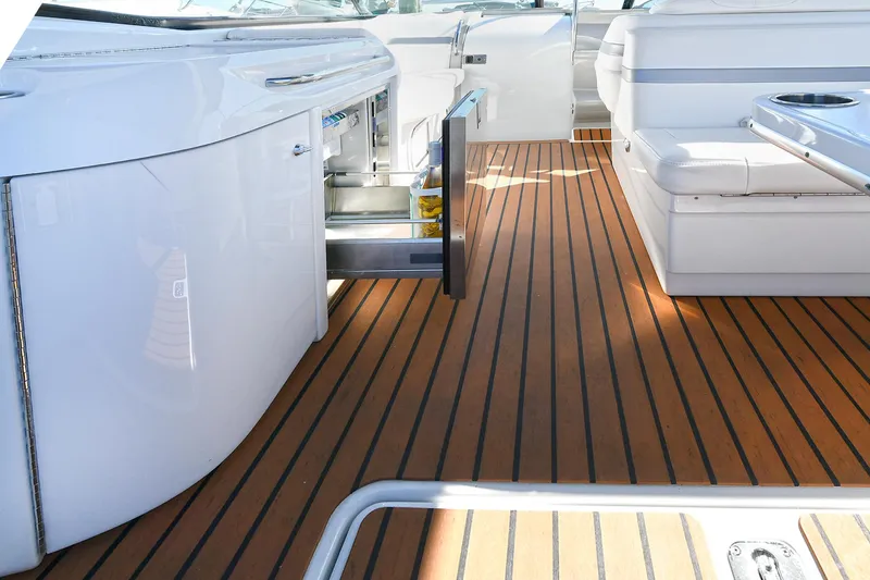 Slide: The Image of 2010 Formula 350 SS boat interior with open storage and wooden flooring. - 32