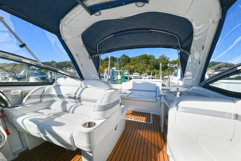 Slide: The Image of 2010 Formula 350 SS boat interior with white seating and wooden flooring. - 33