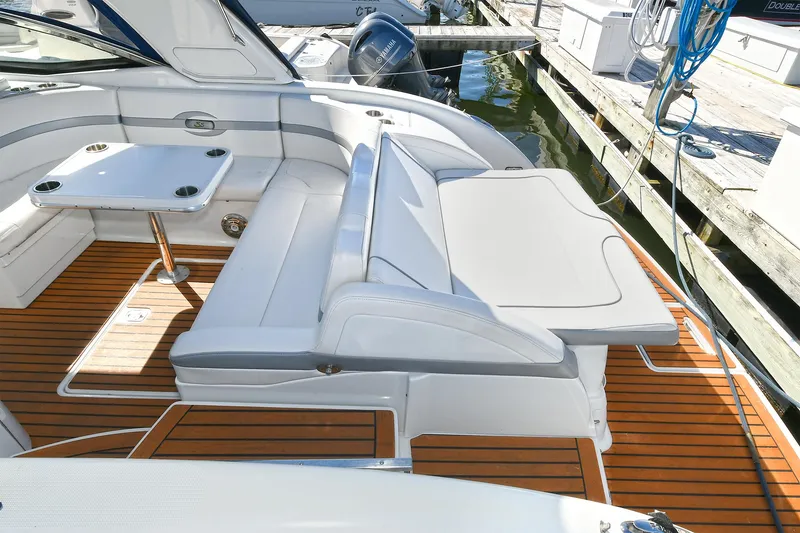 Slide: The Image of 2010 Formula 350 SS boat interior with white seating and wooden deck. - 35