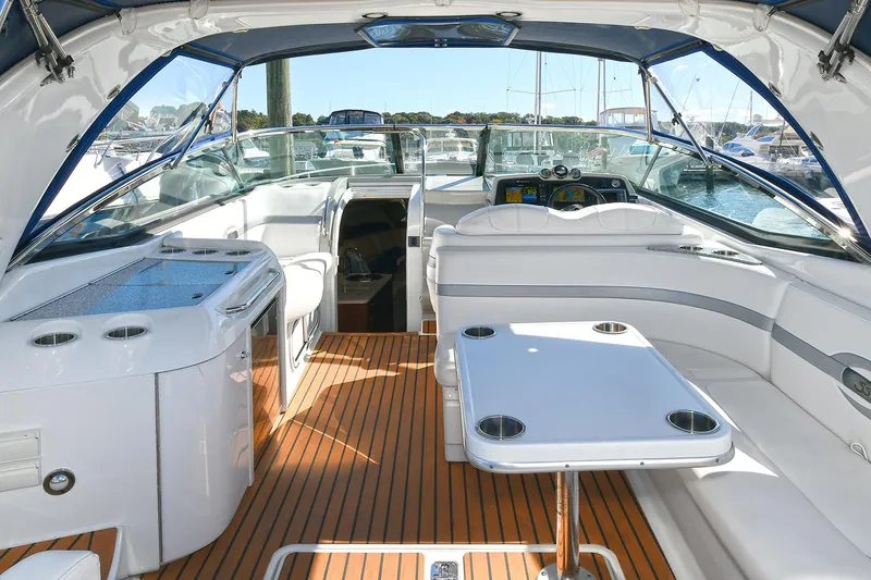Slide: The Image of 2010 Formula 350 SS boat interior with seating and table, docked at marina. - 37