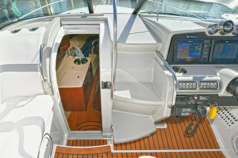Slide: The Image of 2010 Formula 350 SS boat interior with navigation screens and cabin entrance. - 39