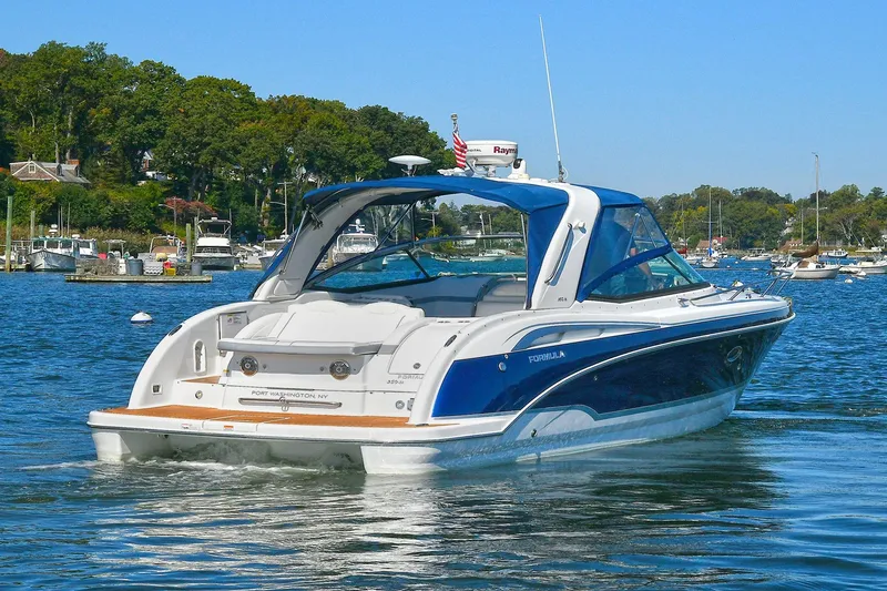 Slide: The Image of 2010 Formula 330 SS Super Sport boat on a scenic lake. - 4