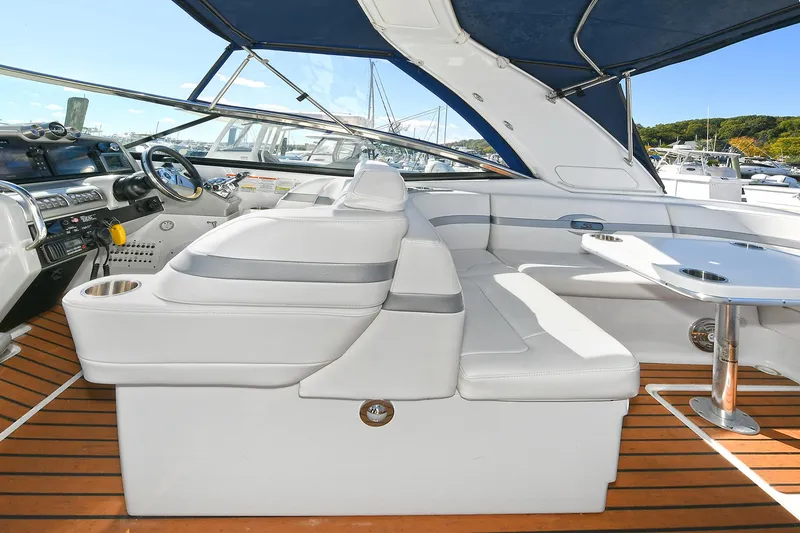 Slide: The Image of 2010 Formula 350 SS boat interior with white seating and wooden flooring. - 40