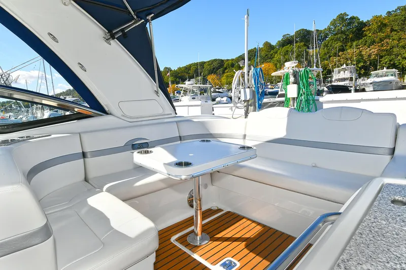 Slide: The Image of 2010 Formula 350 SS boat interior with seating and table, docked at marina. - 41