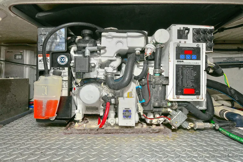 Slide: The Image of Engine compartment of a 2010 Formula 350 SS boat, featuring a Kohler generator. - 43