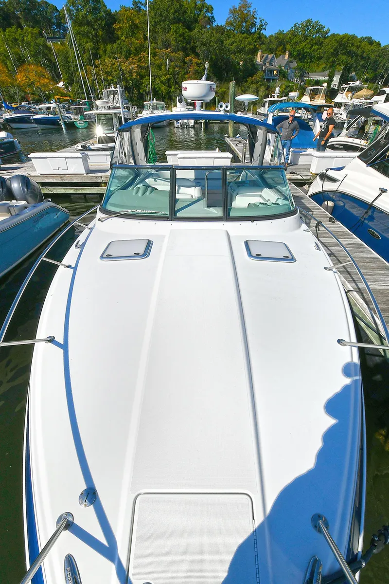 Slide: The Image of 2010 Formula 350 SS boat docked at marina, surrounded by other vessels. - 48