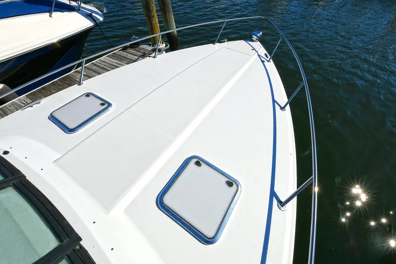 Slide: The Image of 2010 Formula 350 SS boat deck with hatches, docked on calm water. - 49