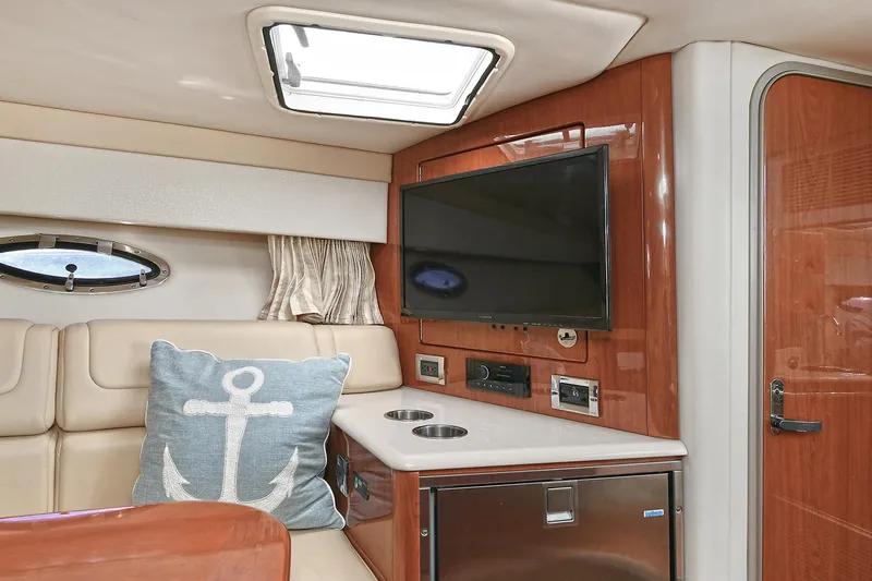 Slide: The Image of Interior of 2010 Formula 350 SS boat with TV, seating, and nautical decor. - 9