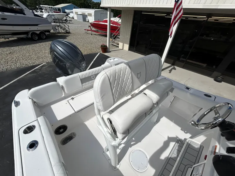 Slide: The Image of 2025 Sea Fox 228 Commander boat interior with white seating and steering wheel. - 10