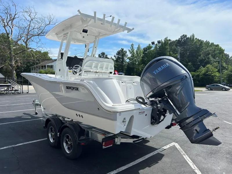 Slide: The Image of 2025 Sea Fox 228 Commander boat with Yamaha engine on a trailer in a parking lot. - 4