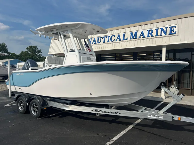Slide: The Image of 2024 Sea Fox 228 Commander boat on trailer outside Nautical Marine store. - 1