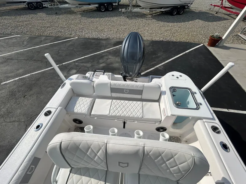 Slide: The Image of 2024 Sea Fox 228 Commander boat interior with cushioned seating and storage compartments. - 12