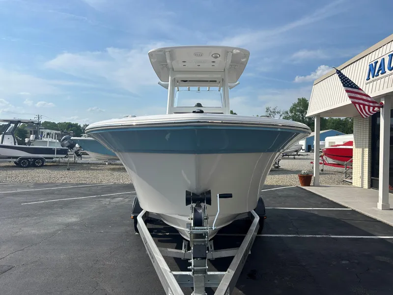 Slide: The Image of 2024 Sea Fox 228 Commander boat on trailer, parked outside dealership. - 2