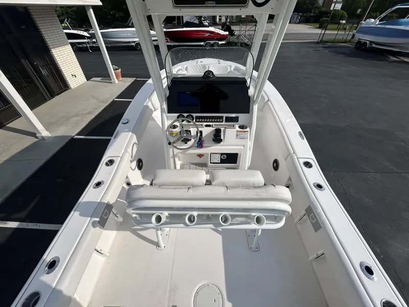 Slide: The Image of 2024 Sea Fox 228 Commander boat interior with helm, seating, and console in a showroom. - 7