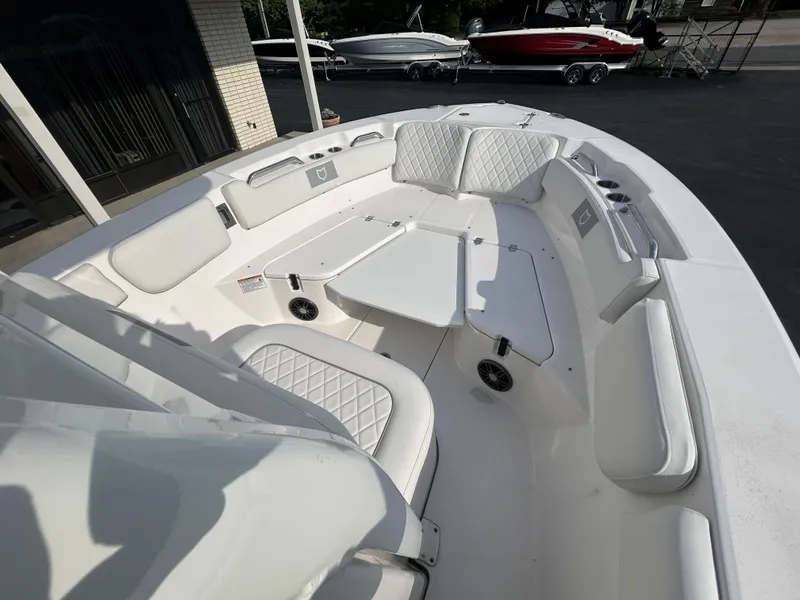 Slide: The Image of 2024 Sea Fox 228 Commander boat interior with white cushioned seating and spacious layout. - 8