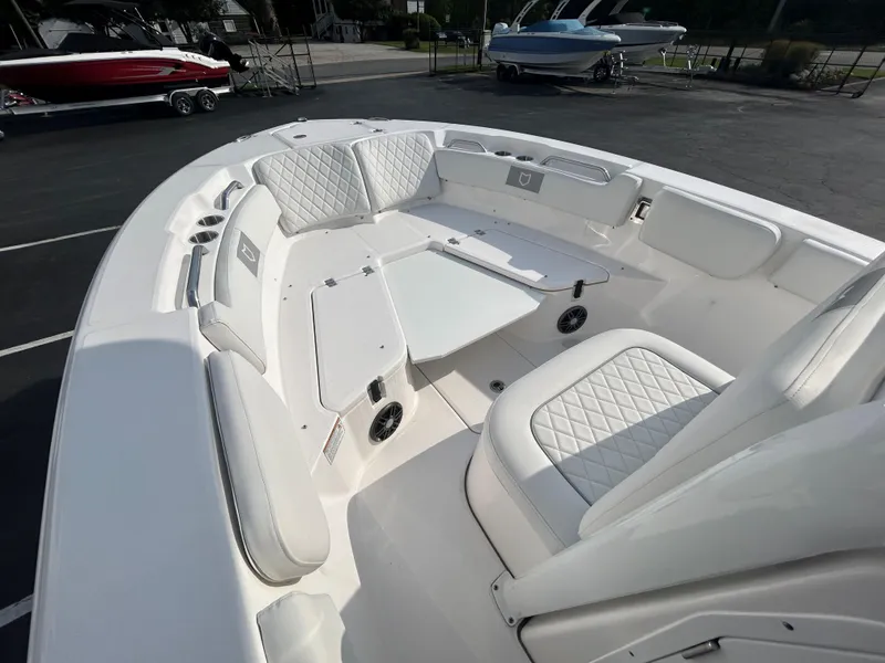 Slide: The Image of 2024 Sea Fox 228 Commander boat interior with white cushioned seating and sleek design. - 9