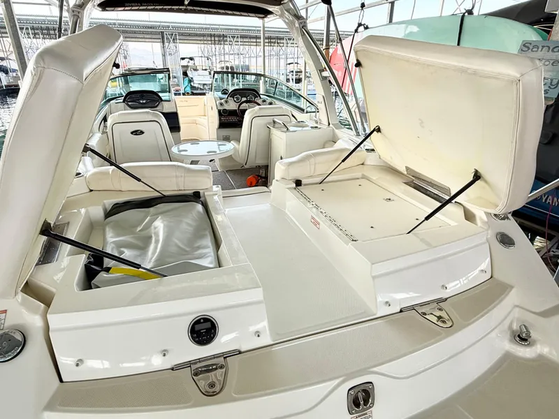 Slide: The Image of 2010 Sea Ray 250 SLX boat with open storage compartments and seating area. - 36