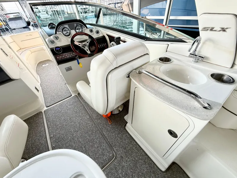 Slide: The Image of Interior of 2010 Sea Ray 250 SLX boat with helm, seating, and sink. - 41