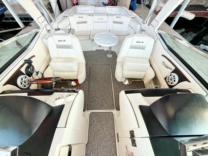 Slide: The Image of 2010 Sea Ray 250 SLX boat interior with white seating and a central table. - 43
