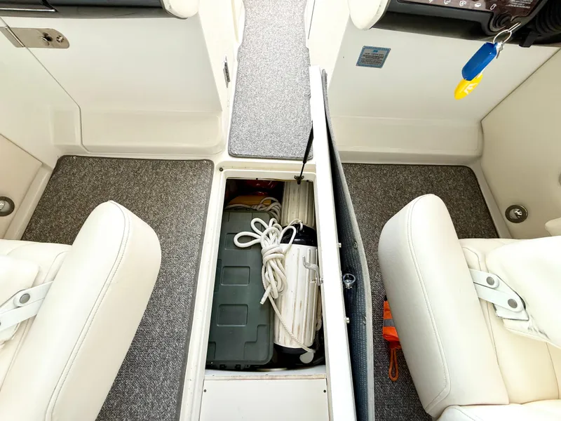 Slide: The Image of 2010 Sea Ray 250 SLX boat interior storage compartment with ropes and equipment. - 45