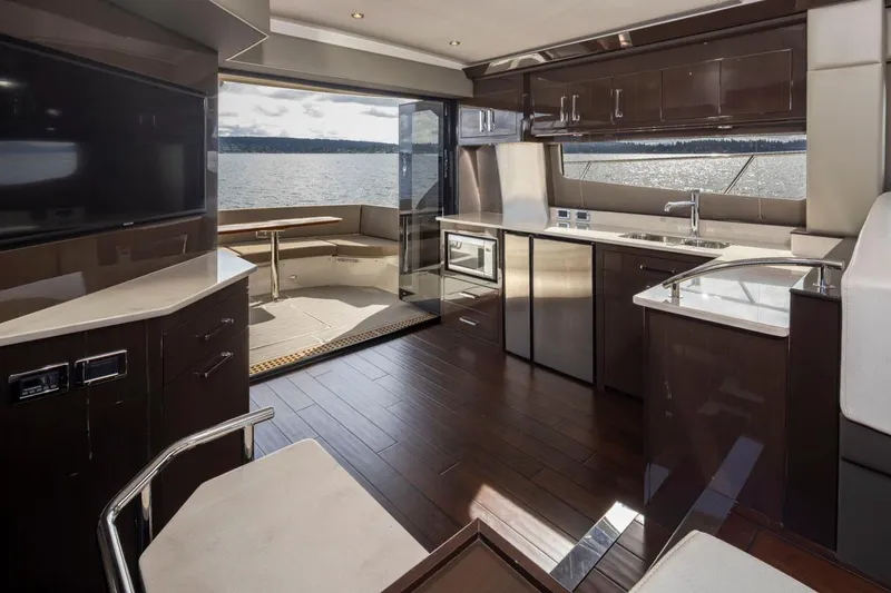 Slide: The Image of Luxurious interior of 2019 Carver C52 Command Bridge yacht with modern kitchen and scenic view. - 18