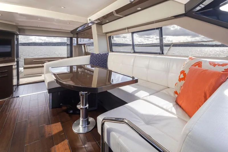 Slide: The Image of Luxurious interior of 2019 Carver C52 Command Bridge yacht with elegant seating and scenic water view. - 20