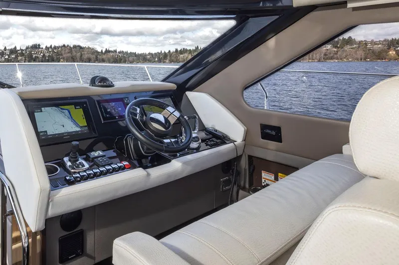 Slide: The Image of 2019 Carver C52 Command Bridge interior with navigation controls and steering wheel. - 25