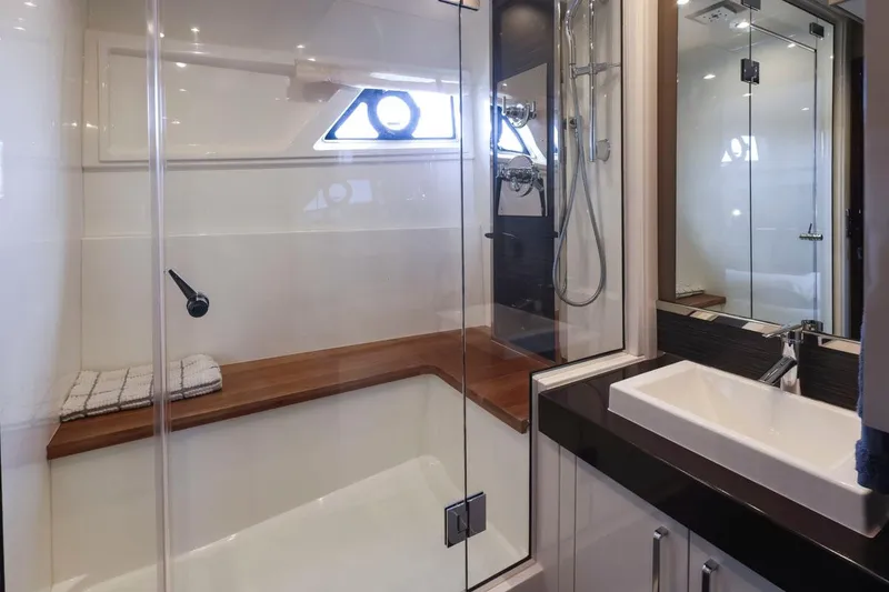 Slide: The Image of Luxurious bathroom in 2019 Carver C52 Command Bridge yacht with modern fixtures and glass shower. - 31