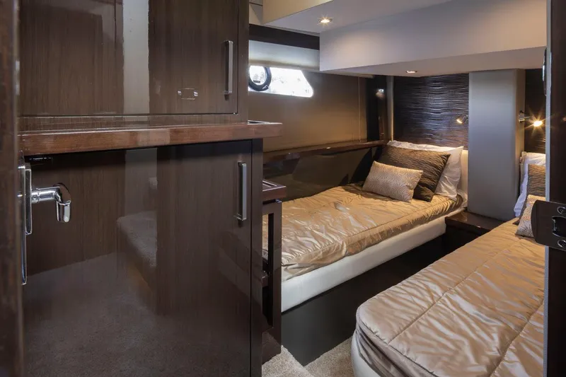 Slide: The Image of 2019 Carver C52 Command Bridge cabin with twin beds and modern interior design. - 38