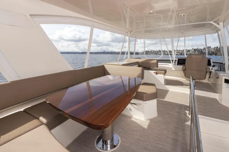 Slide: The Image of 2019 Carver C52 Command Bridge interior with elegant seating and polished wooden table. - 42