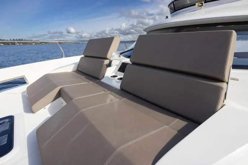 Slide: The Image of 2019 Carver C52 Command Bridge yacht with luxurious sun loungers on deck. - 46