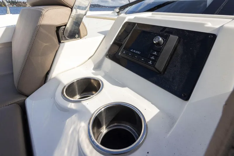 Slide: The Image of Interior of 2019 Carver C52 Command Bridge with cup holders and control panel. - 47