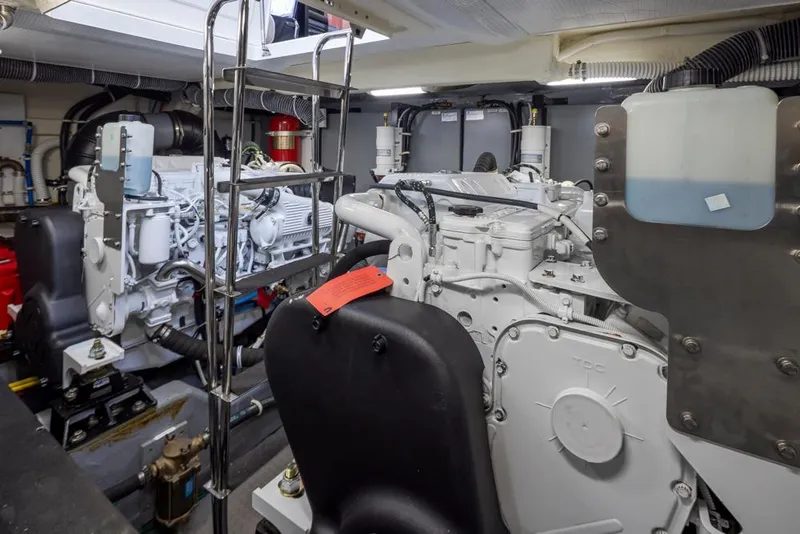 Slide: The Image of Engine room of 2019 Carver C52 Command Bridge yacht, showcasing dual engines and mechanical components. - 48