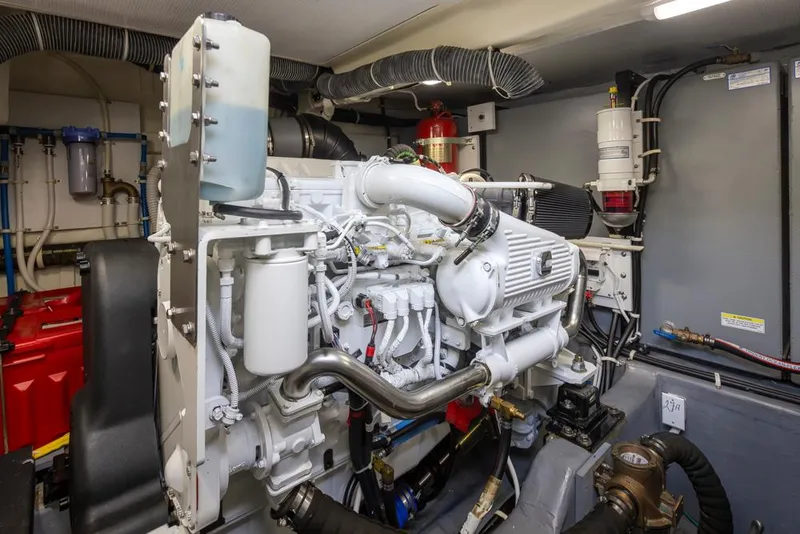 Slide: The Image of Engine room of 2019 Carver C52 Command Bridge yacht, showcasing detailed machinery and components. - 49