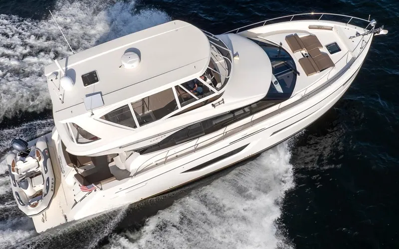 Slide: The Image of 2019 Carver C52 Command Bridge yacht cruising on open water. - 8