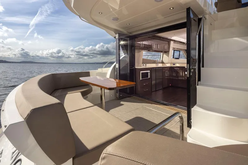Slide: The Image of 2019 Carver C52 Command Bridge yacht with open deck and luxurious interior. - 9