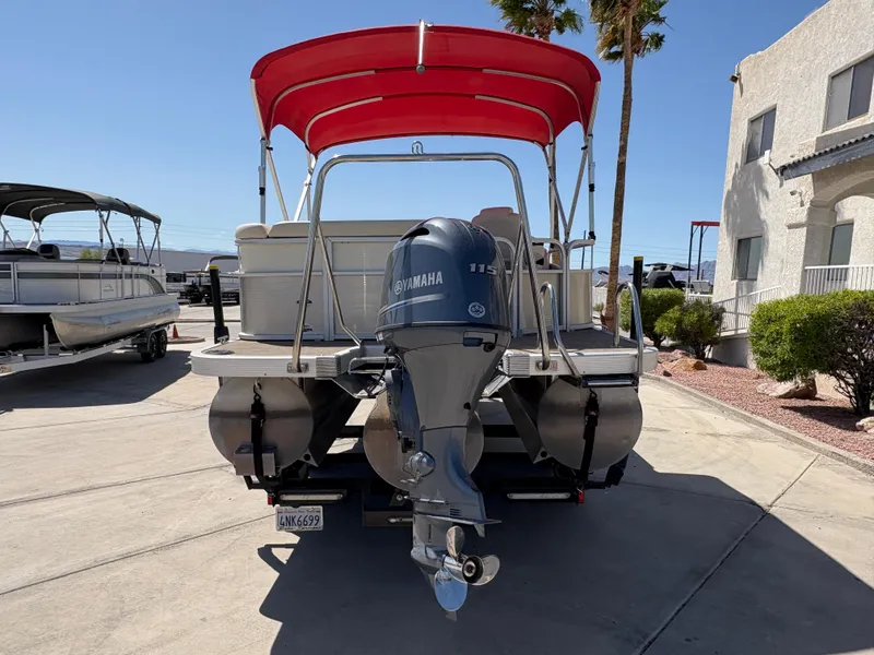 Slide: The Image of 2015 Bennington 21 SLX SPS pontoon boat with Yamaha engine and red canopy. - 3