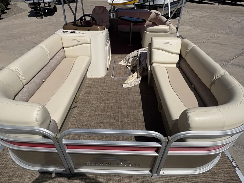 Slide: The Image of 2015 Bennington 21 SLX SPS pontoon boat with beige seating and spacious interior. - 4