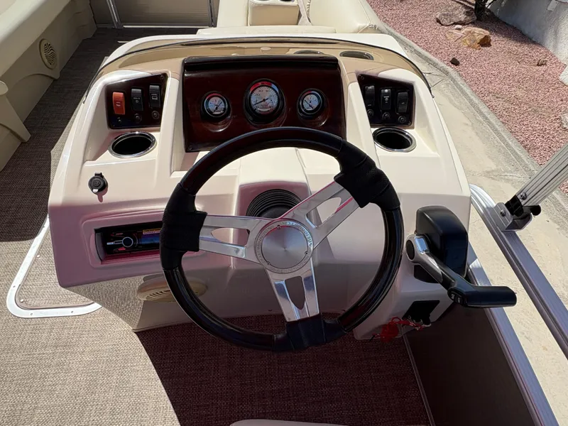 Slide: The Image of 2015 Bennington 21 SLX SPS boat dashboard with steering wheel and control panel. - 6
