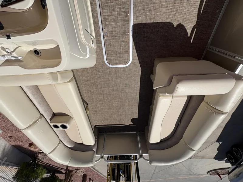 Slide: The Image of 2015 Bennington 21 SLX SPS pontoon boat interior with beige seating and carpet flooring. - 7