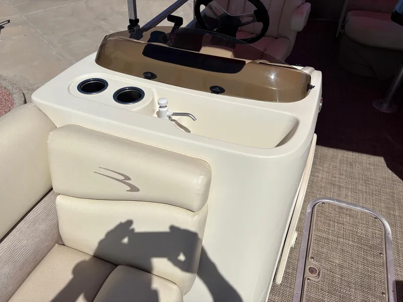 Slide: The Image of 2015 Bennington 21 SLX SPS boat interior with beige seating and console. - 8