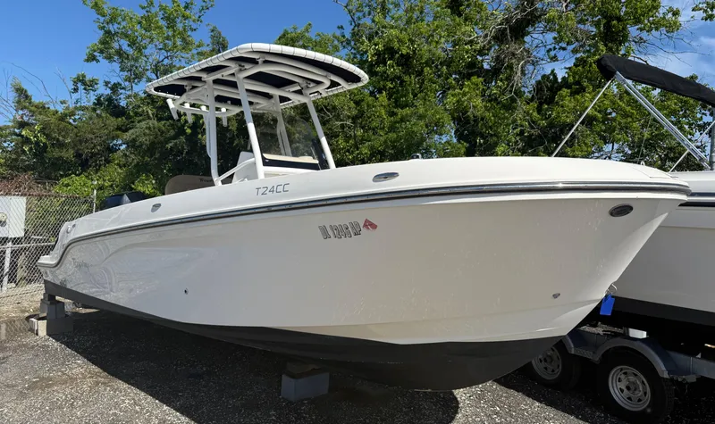 Slide: The Image of 2022 Trophy T24CC boat on display, white hull, outdoor setting. - 0