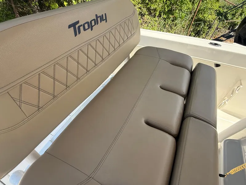 Slide: The Image of 2022 Trophy T24CC boat seat with beige upholstery and logo detailing. - 10