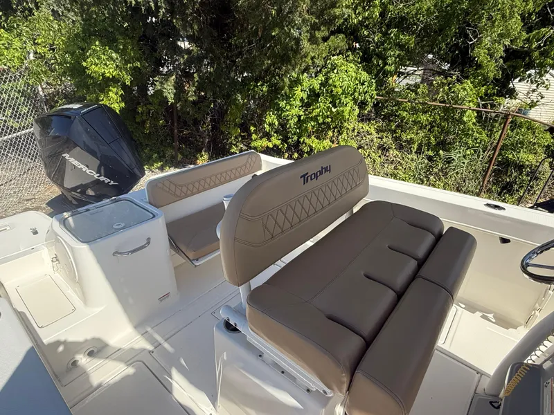 Slide: The Image of 2022 Trophy T24CC boat interior with tan seating and outboard motor. - 12