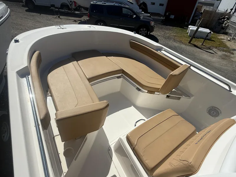 Slide: The Image of 2022 Trophy T24CC boat with beige seating in a spacious deck layout. - 14
