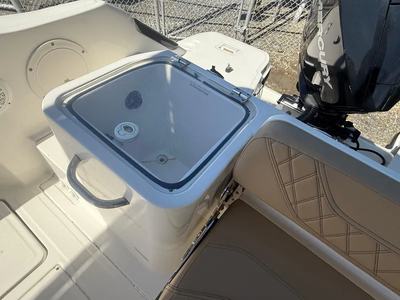 Slide: The Image of 2022 Trophy T24CC boat interior with seating and storage compartment. - 15